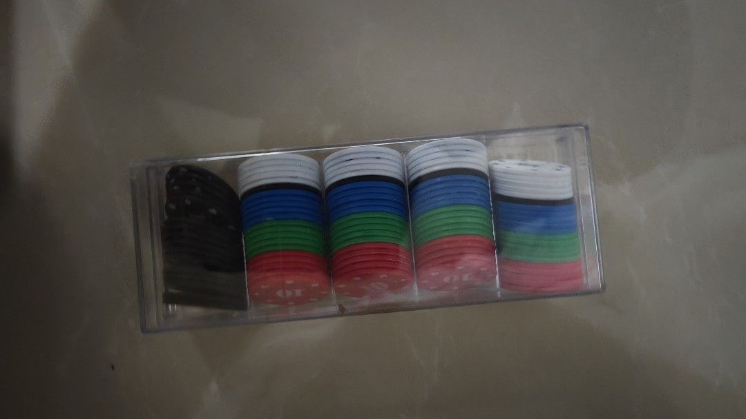 Poker Chips Set with Case (Category: Board Games & Puzzles) located in Singapore. Submitted by 2ndmiie (Listing ID 1458047708, Image 2). Description: - Move-out Sales, Price Negotiable 🤩 - Complete poker chip set - Comes with a clear plastic case for easy storage and transport - Includes chips in five colors: black, blue, red, green, and white - Features denominations such as 100, 50, 20, 10, and 5 - Ideal for hosting your next game night or pok
