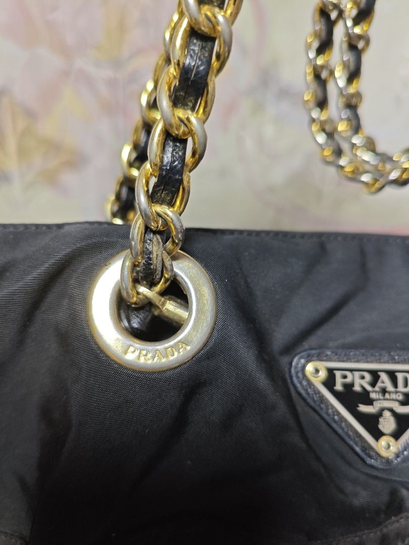 Authentic Vintage Prada Quilted Nylon Tessuto Bag (Category: Luxury Bags & Wallets) located in Davao. Submitted by skankinpotato101 (Listing ID 1457999568, Image 3). Description: - Authentic Black Prada Shoulder Bag - Quilted Nylon Material - Gold Chain Straps - Iconic Prada Triangle Logo - Zipper Closure.
