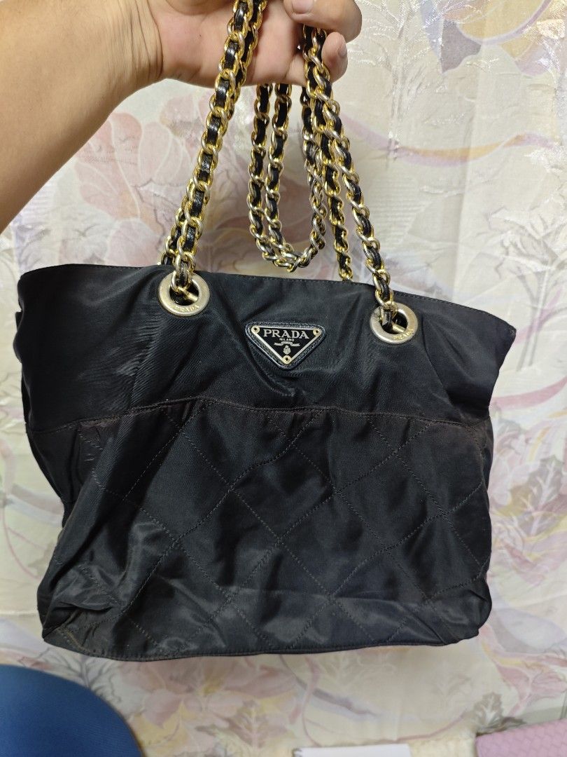 Authentic Vintage Prada Quilted Nylon Tessuto Bag (Category: Luxury Bags & Wallets) located in Davao. Submitted by skankinpotato101 (Listing ID 1457999568, Image 1). Description: - Authentic Black Prada Shoulder Bag - Quilted Nylon Material - Gold Chain Straps - Iconic Prada Triangle Logo - Zipper Closure.