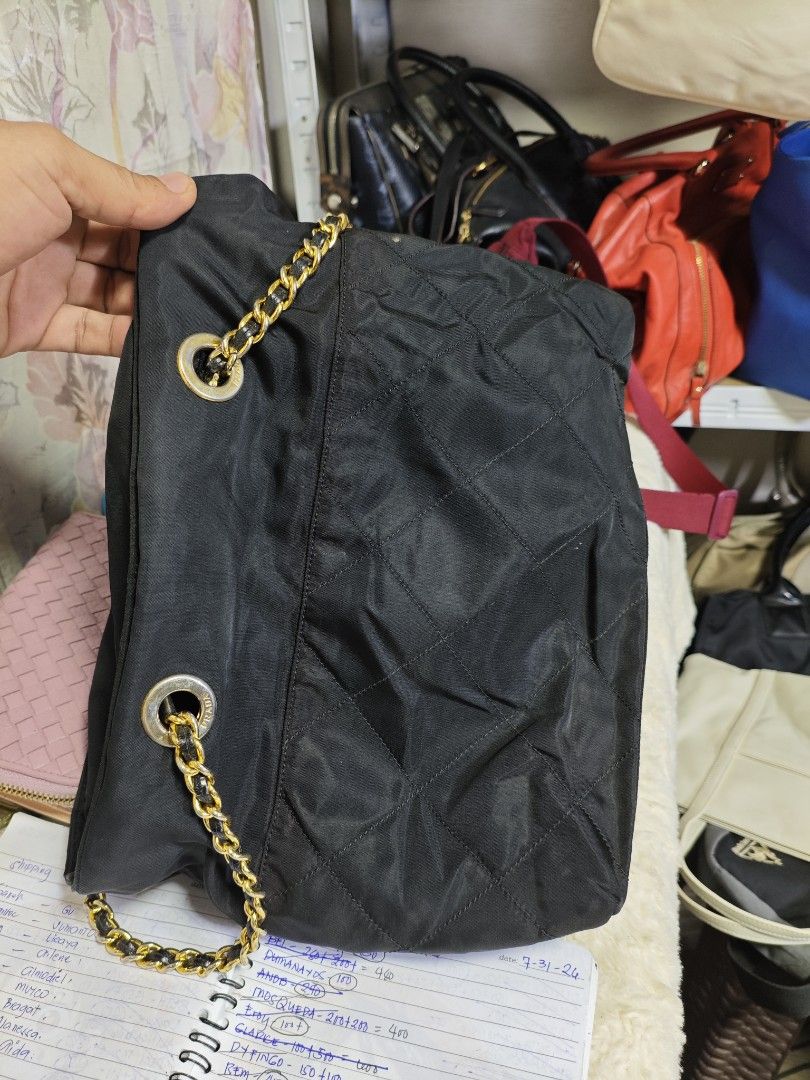 Authentic Vintage Prada Quilted Nylon Tessuto Bag (Category: Luxury Bags & Wallets) located in Davao. Submitted by skankinpotato101 (Listing ID 1457999568, Image 2). Description: - Authentic Black Prada Shoulder Bag - Quilted Nylon Material - Gold Chain Straps - Iconic Prada Triangle Logo - Zipper Closure.