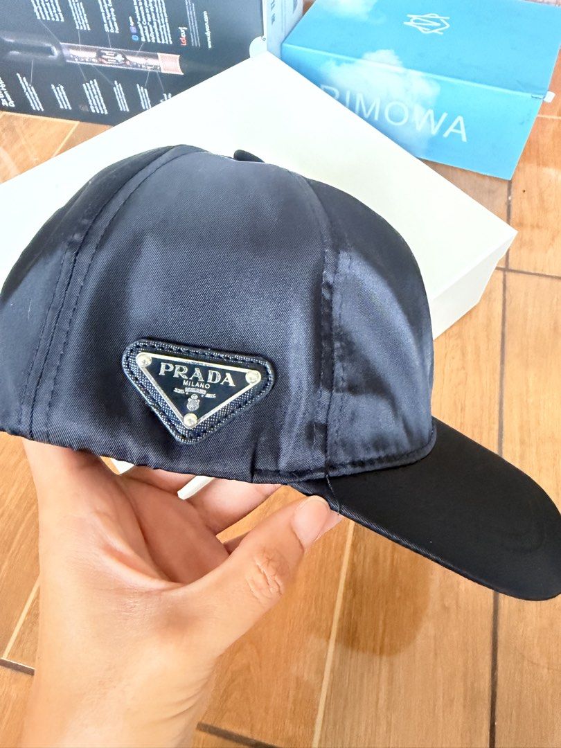 Pr@da Black Nylon Cap (Category: Caps & Hats) located in Las Pinas. Submitted by twiceloved24 (Listing ID 1457972380, Image 1). Description: - Black nylon material - Iconic Prada triangle logo on front - Adjustable strap for a comfortable fit - Ideal for everyday wear.