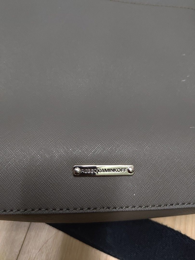 Rebecca Minkoff Grey Laptop Bag (Category: Luxury Bags & Wallets) located in Cagayan de Oro. Submitted by ps1030 (Listing ID 1457988974, Image 3). Description: - Brand: Rebecca Minkoff - Color: Grey - Material: Saffiano Leather - Features: Signature metal logo plate, comes with a black strap - Size: Ideal for everyday use.
