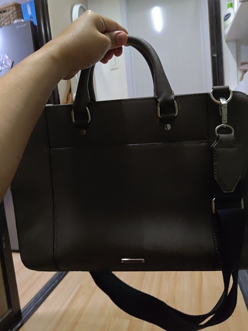 Rebecca Minkoff Grey Laptop Bag (Category: Luxury Bags & Wallets) located in Cagayan de Oro. Submitted by ps1030 (Listing ID 1457988974, Image 2). Description: - Brand: Rebecca Minkoff - Color: Grey - Material: Saffiano Leather - Features: Signature metal logo plate, comes with a black strap - Size: Ideal for everyday use.