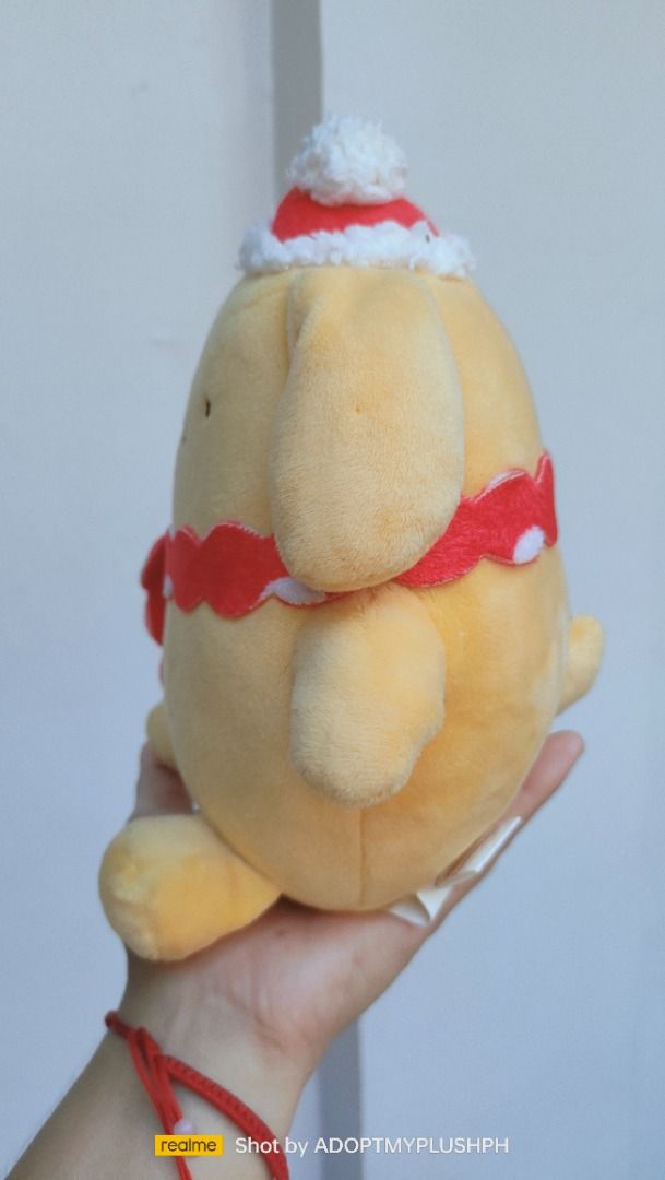 Sanrio Pompompurin Holiday plush (Category: Plushies & Soft Toys) located in Taguig. Submitted by adopt.my.plush.ph (Listing ID 1457903409, Image 3). Description: Pompompurin holiday plush toy featuring the Sanrio character dressed in a small Santa hat and a red-and-white wavy scarf. Manufacturer: E-STRONG / 长亿玩具 (Changsha Changyi Toys Co., Ltd.).