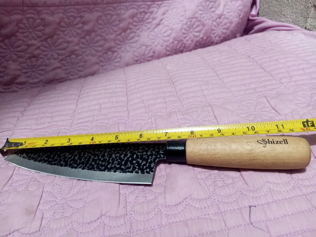 Shizell knives (Category: Knives & Chopping Boards) located in Pasig City. Submitted by urdal01 (Listing ID 1458033818, Image 2). Description: Shizell Tsuchime Santoku knife, featuring a hammered black-and-silver textured blade finish and a light wooden handle..