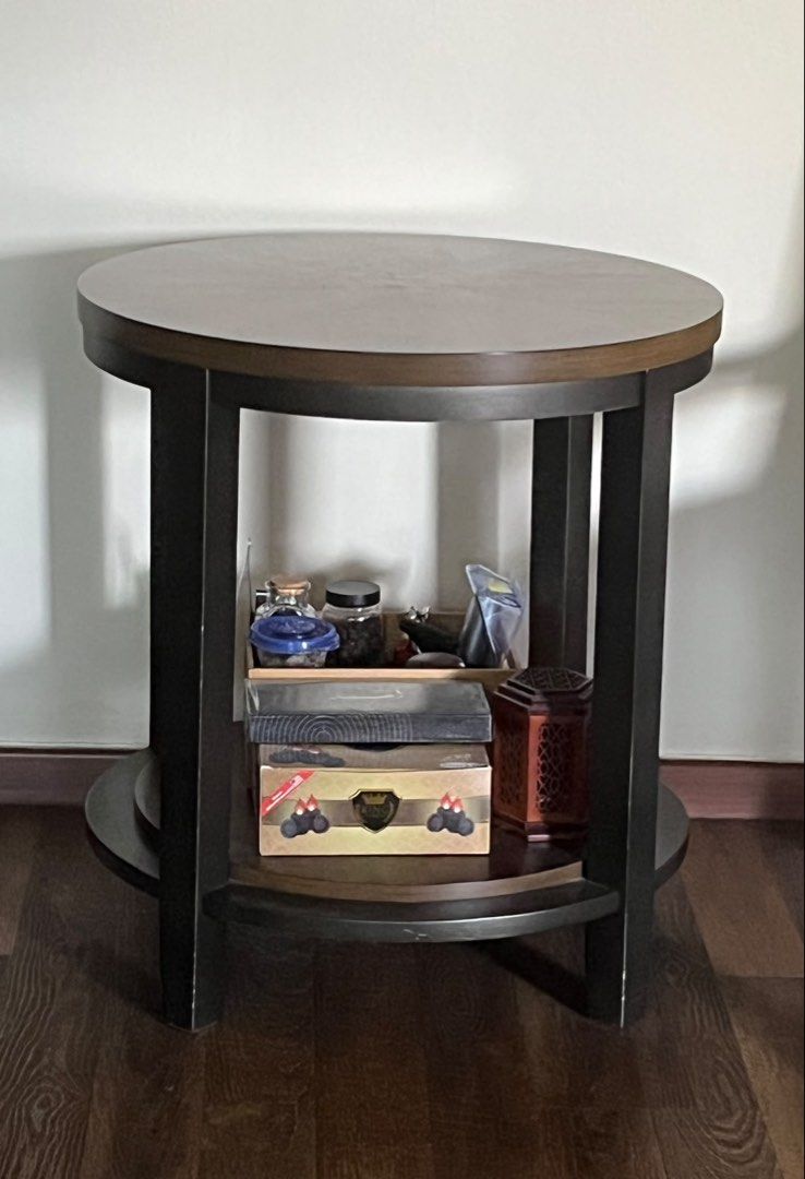 Side table (Category: Tables & Sets) located in Singapore. Submitted by the.petite.wardrobe (Listing ID 1457923448, Image 1). Description: - Round side table - Lower shelf for extra storage - Ideal for living room or bedroom - Height: 64cm Diameter: 59cm - Not for fussy buyer.