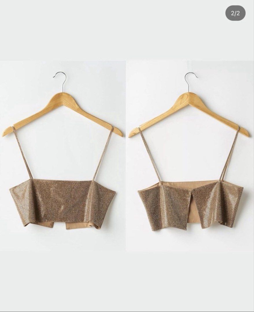 Sparkly Gold Square Neck Crop Top (Category: Sleeveless) located in Pasig City. Submitted by lmbasa (Listing ID 1457988537, Image 2). Description: - Gold sparkly crop top - Thin straps - Square neckline - Hook and eye closure at the back - Ideal for parties and nights out - Versatile: pair with skirts or high-waisted pants.