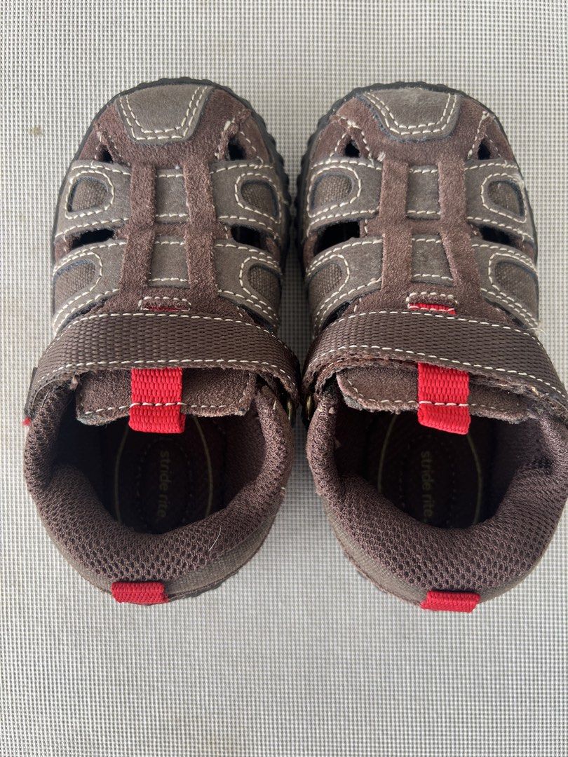 STRIDE RITE (Category: Babies & Kids Fashion) located in Kuala Lumpur. Submitted by nurulmz (Listing ID 1458013931, Image 1). Description: - Brand: Stride Rite - Type: Kids' Sandals - Color: Brown with red accents - Material: Suede and canvas upper - Closure: Adjustable hook-and-loop strap - Features: Durable sole with good grip, breathable design - Size: US6.5W, UK6, EU23.
