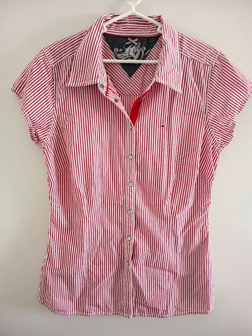 Tommy Hilfiger Denim Red Striped Short Sleeve Shirt (Category: Shirts) located in Cagayan de Oro. Submitted by edwardryan01984 (Listing ID 1447129708, Image 2). Description: - Tommy Hilfiger Denim Shirt - Length 27 inches - Width 17 inches - Classic red and white stripes - Short sleeves - Button-up front - Small logo on chest pocket - Unique collar detail - Ideal for casual wear.