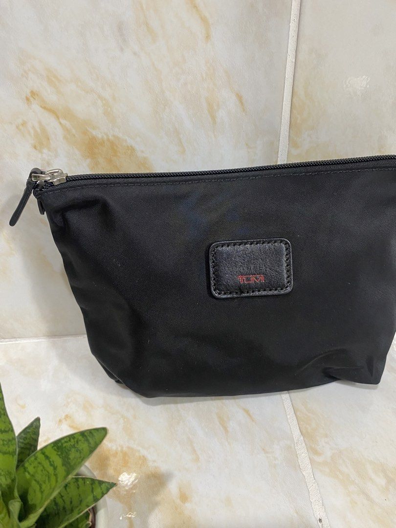 Tumi Black Nylon Cosmetic Bag Pouch (Category: Luxury Bags & Wallets) located in Manila. Submitted by haveago0dthrift (Listing ID 1457959667, Image 2). Description: - Brand: Tumi - Color: Black - Material: Durable Nylon - Features: Classic Tumi leather logo patch, secure zipper closure - Use: Ideal for travel or everyday organization - Size: Compact, fits easily in bags.