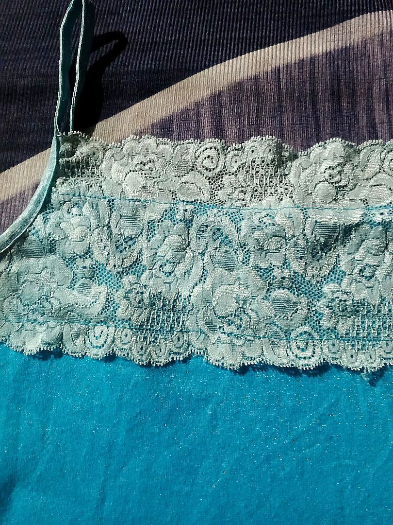 Turquoise Camisole with Lace Trim (Category: Sleeveless) located in Manila. Submitted by icamalicdem29 (Listing ID 1458022302, Image 2). Description: - Beautiful turquoise camisole - Delicate lace trim on the right side - Thin spaghetti straps for a delicate look - Made from soft, comfortable fabric - Perfect for layering or wearing as a standalone piece - Easily pairs with various outfits.