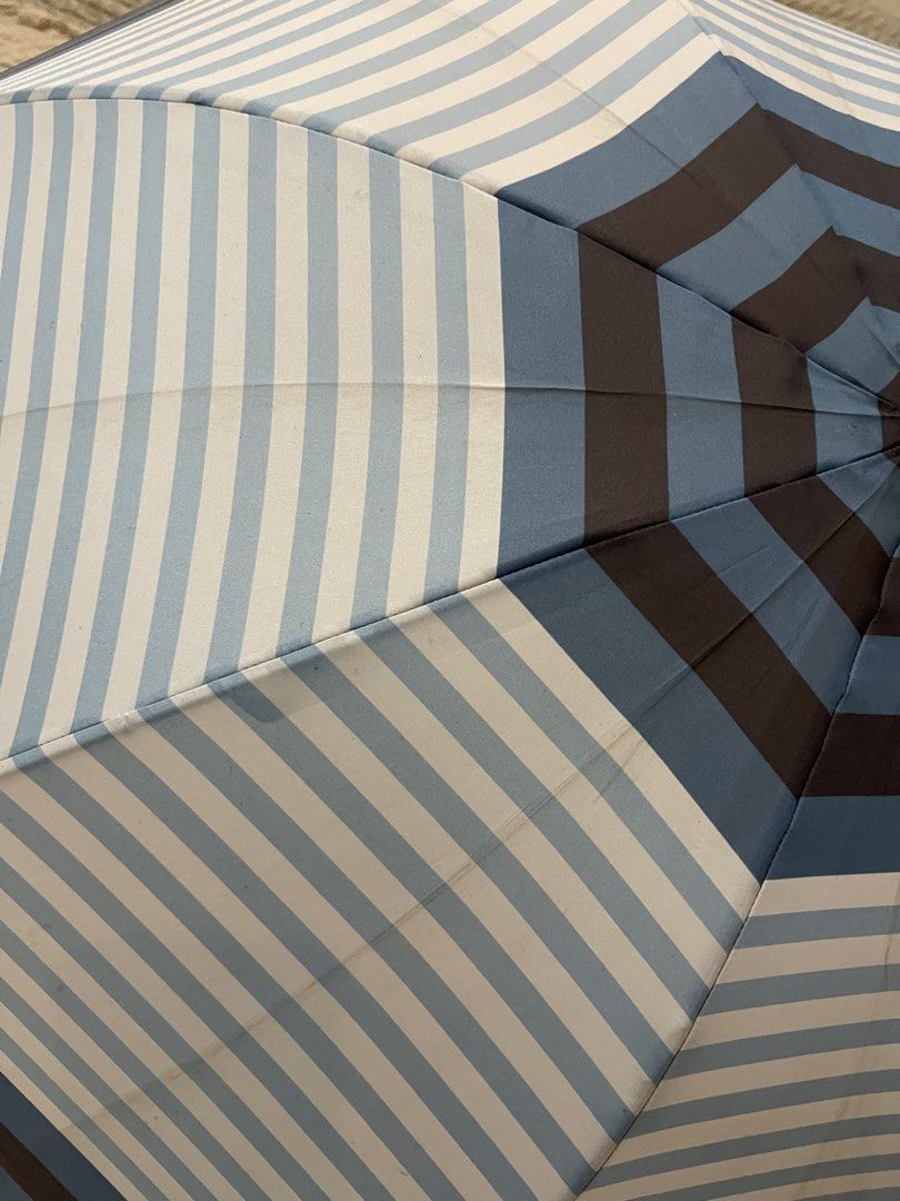 umbrella with a geometric blue, white, and brown stripe pattern (Category: Umbrellas) located in San Fernando. Submitted by japansurpluselyu (Listing ID 1458025755, Image 2). Description: .