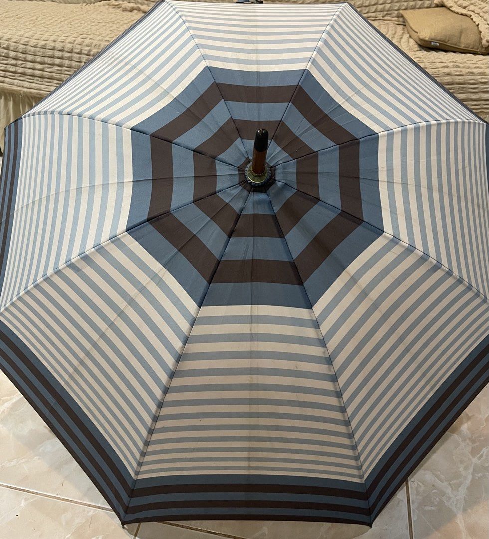 umbrella with a geometric blue, white, and brown stripe pattern (Category: Umbrellas) located in San Fernando. Submitted by japansurpluselyu (Listing ID 1458025755, Image 1). Description: .