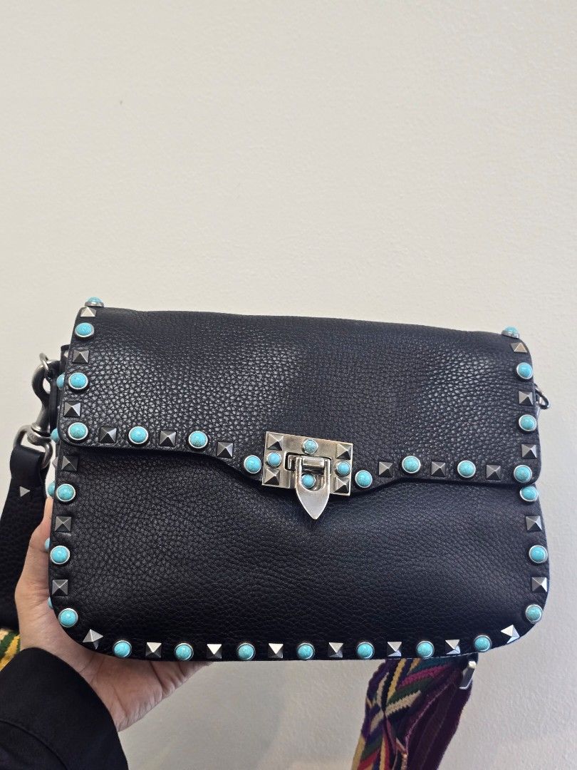 Valentino Black Rolling Rockstud Crossbody Bag (Category: Luxury Bags & Wallets) located in Taguig. Submitted by mluxeph (Listing ID 1457932658, Image 1). Description: Valentino Black Rolling Rockstud Crossbody Bag Material: Pebble leather Stamp: CB-K053VH72 Interior: Three main compartments and one zip pocket Measurements: 10.25”L X 3”W X 7.6”H Handle Drop: 22.5" adjustable Hardware: Silver tone Inclusions: Original dust bag, care card and extra