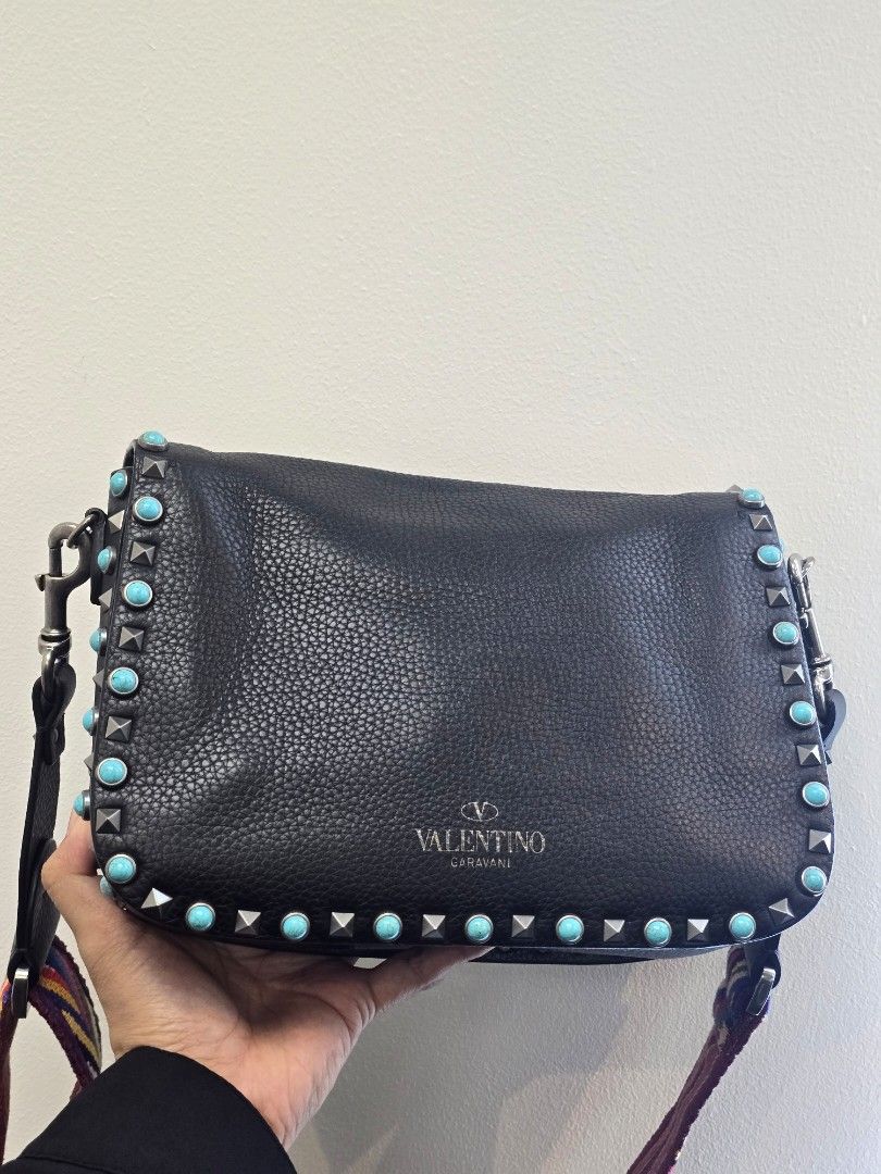 Valentino Black Rolling Rockstud Crossbody Bag (Category: Luxury Bags & Wallets) located in Taguig. Submitted by mluxeph (Listing ID 1457932658, Image 2). Description: Valentino Black Rolling Rockstud Crossbody Bag Material: Pebble leather Stamp: CB-K053VH72 Interior: Three main compartments and one zip pocket Measurements: 10.25”L X 3”W X 7.6”H Handle Drop: 22.5" adjustable Hardware: Silver tone Inclusions: Original dust bag, care card and extra