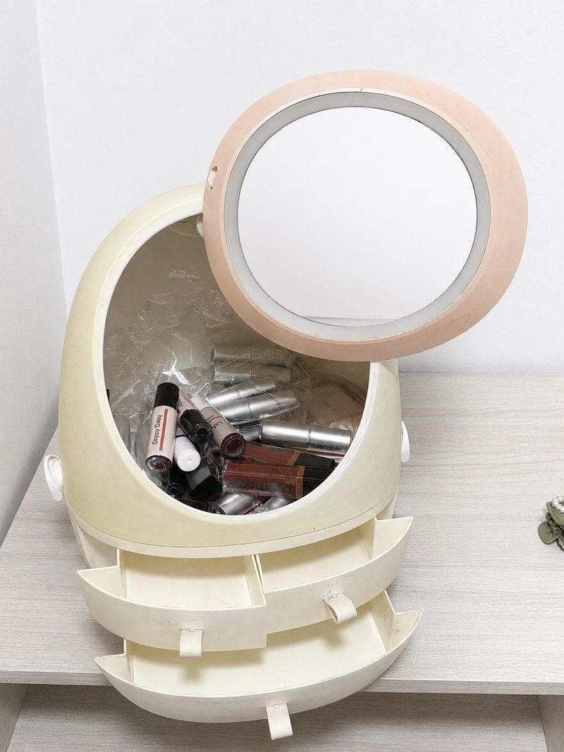 Vanity Makeup Organizer with Lighted Mirror and Drawers (Category: Makeup) located in Quezon City. Submitted by boldcat_343a70 (Listing ID 1458065054, Image 2). Description: - Cute egg-shaped makeup organizer - Built-in lighted mirror on top (flips open) - Spacious interior for lipsticks and cosmetics - Two bottom drawers for additional storage - Perfect for a tidy vanity - Light is fully functional Selling my preloved LED vanity mirror with a bu