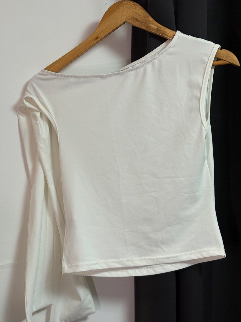 White Asymmetrical Long Sleeve Crop Top (Category: Longsleeves) located in Manila. Submitted by jeweeeel (Listing ID 1458030236, Image 2). Description: - Trendy white crop top - Unique asymmetrical design: one long sleeve, one sleeveless - Flattering asymmetrical neckline - Comfortable stretchy material - Versatile: great for layering or wearing solo - Simple, chic, and fits well.