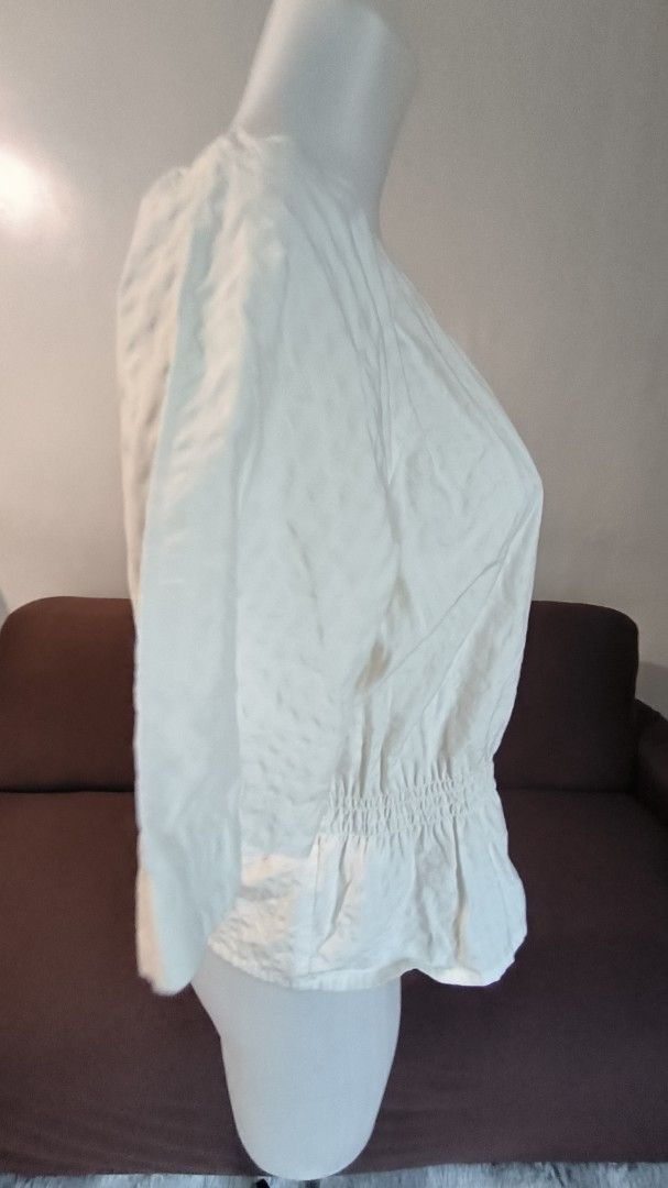 White Blouse with Button Front (Category: Blouses) located in Antipolo. Submitted by secondcharmstore (Listing ID 1457984230, Image 3). Description: -size: medium -chest: 38-40 inches -length: 22.5 inches - White blouse - Smocked neckline - Elasticated waist - Short sleeves - Button-up front - Textured fabric - Can be tucked in or worn out - Perfect for casual or dressy occasions.