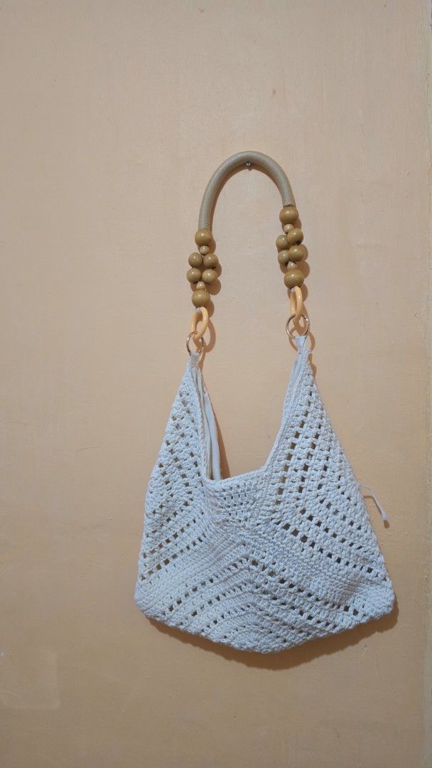 White Crocheted Shoulder Bag with Wooden Beads (Category: Shoulder Bags) located in Balamban. Submitted by macabebe (Listing ID 1458024229, Image 1). Description: - White crocheted shoulder bag - Unique open-knit pattern - Rope-like handles with wooden beads and light-colored rings - Ideal for a casual, bohemian style - Spacious enough for daily essentials.