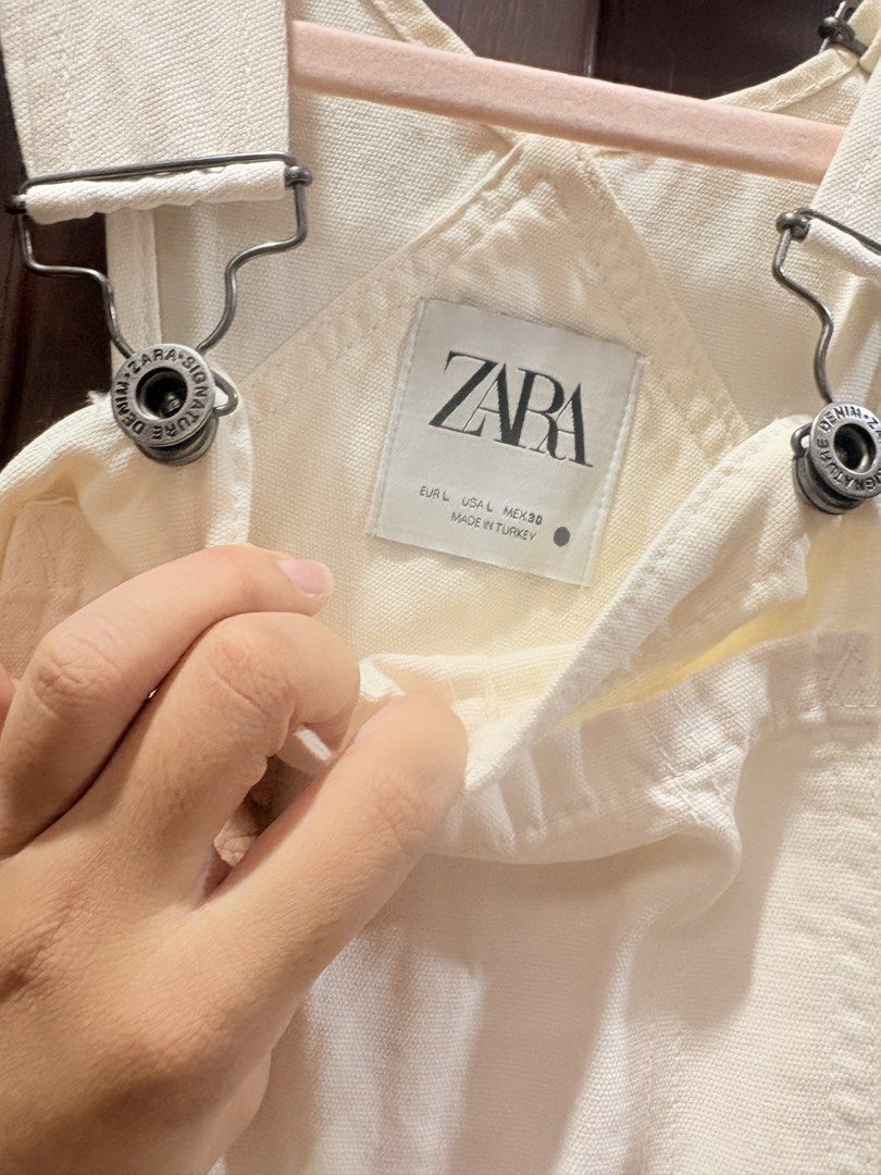 Zara Cream Denim Overalls Size L (Category: Jumpsuits) located in Manila. Submitted by sofiacarm15 (Listing ID 1458039271, Image 3). Description: Cream colored denim overalls from Zara. Size L. Has a bib pocket and two side pockets. Adjustable straps with buckle closure. Button closure on the sides. Made in Turkey. Great for a casual look..