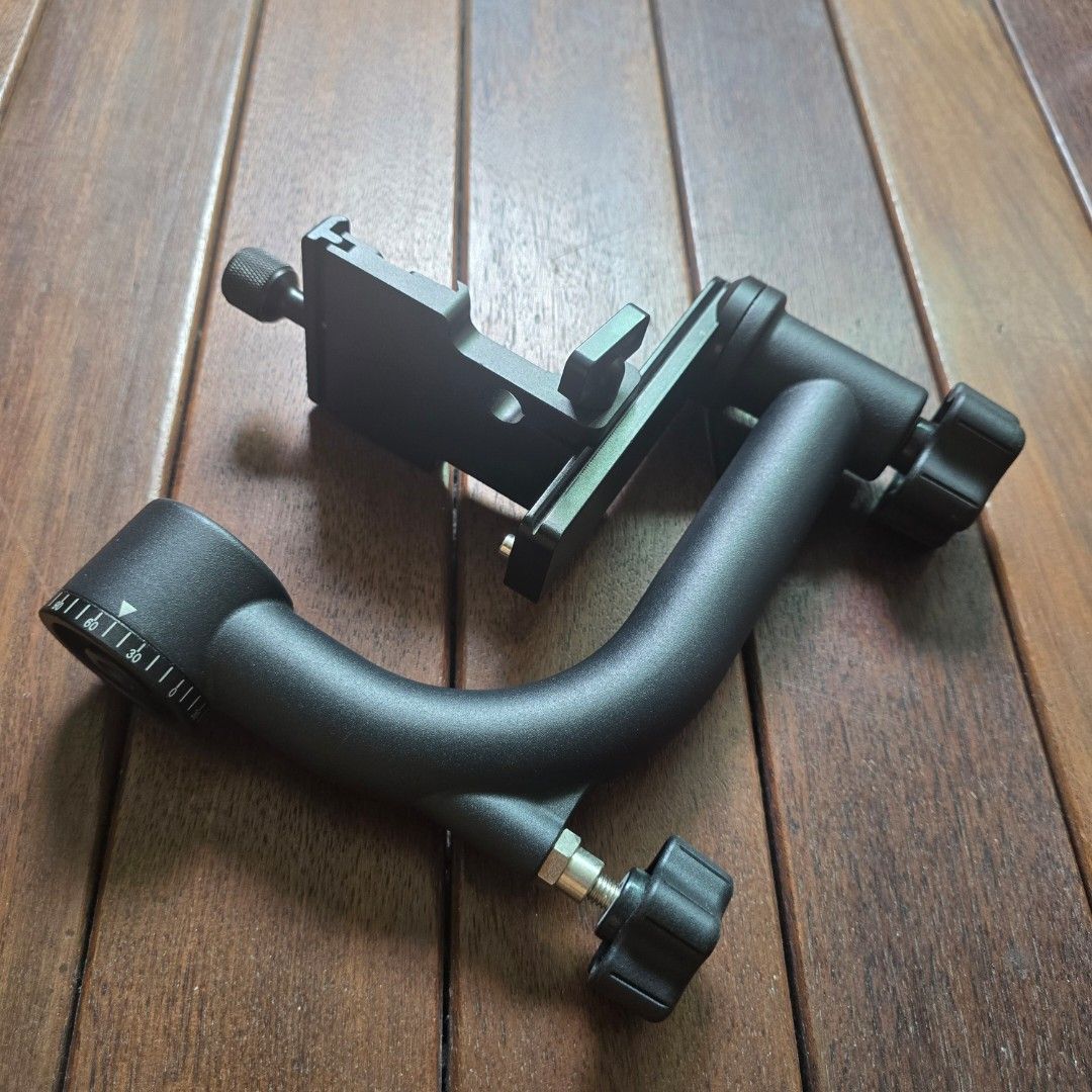 Adjustable Camera Mount Bracket Arm (Category: Tripods & Monopods) located in Singapore. Submitted by gohst2026 (Listing ID 1458115539, Image 2). Description: - Black metal camera mount - Adjustable knobs for easy positioning - Flexible curved arm for various angles - Includes a clamp for secure attachment - Ideal for photography setups.
