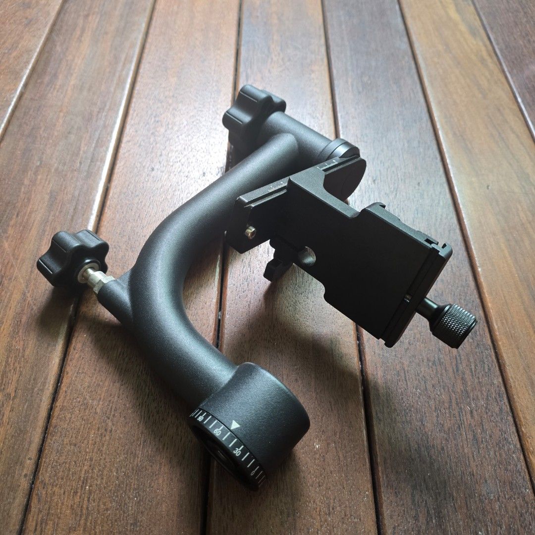 Adjustable Camera Mount Bracket Arm (Category: Tripods & Monopods) located in Singapore. Submitted by gohst2026 (Listing ID 1458115539, Image 3). Description: - Black metal camera mount - Adjustable knobs for easy positioning - Flexible curved arm for various angles - Includes a clamp for secure attachment - Ideal for photography setups.