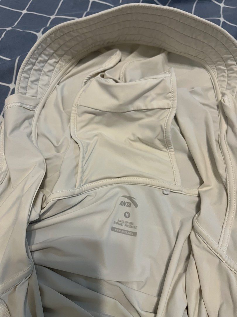 ANTA Lightweight Hoodie Jacket Size M (Category: Coats, Jackets and Outerwear) located in Mandaluyong City. Submitted by _cfpl (Listing ID 1458194392, Image 2). Description: - Lightweight ANTA hoodie jacket - Color: Cream - Size: Medium (M) - Material: 88% Polyamide, 12% Elastane - Features thumbholes on sleeves - Full front zipper - Small logo detail on chest - Ideal for outdoor activities and casual wear.