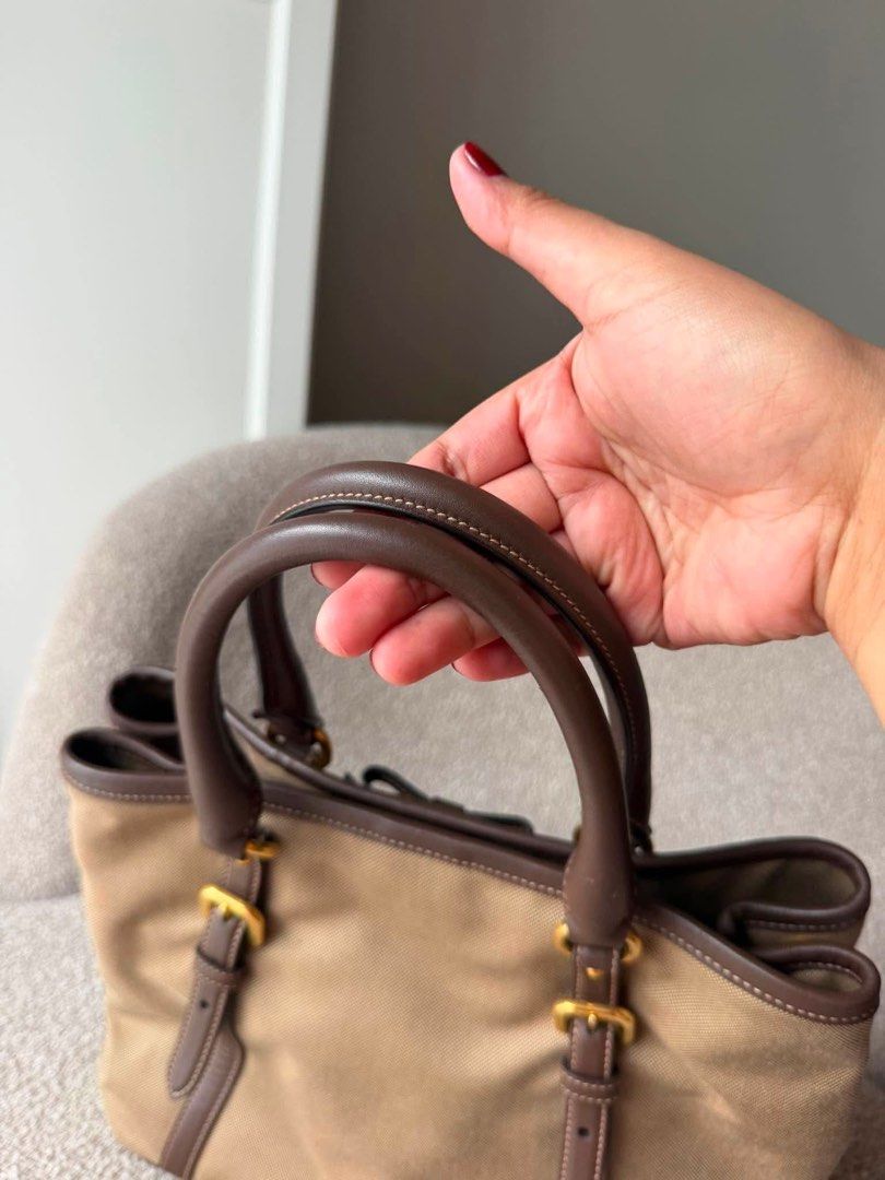 Authentic Prada Logo Jacquard Bow Tote (Category: Luxury Bags & Wallets) located in Quezon City. Submitted by jhaediah (Listing ID 1448706591, Image 2). Description: Authentic No foul smell Preloved with dustbag and leather strap.