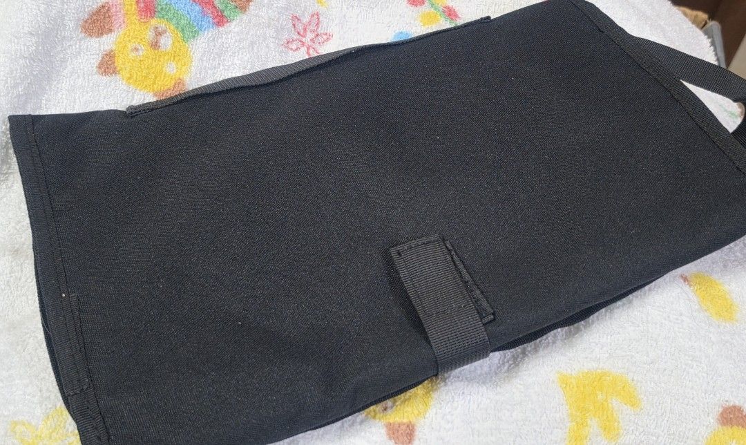 Diaper Changing Pad (Category: Changing Mats & Accessories) located in Quezon City. Submitted by lois_bns (Listing ID 1458276040, Image 1). Description: Unused baby diaper changing pad. Black in color, big/wide in size. With wet wipes and diaper side slot. Good for travel. Can send videos as well..