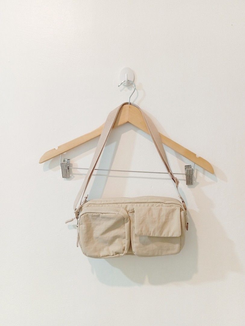 Beige Crossbody Bag with Multiple Pockets (Category: Cross-body Bags) located in Manila. Submitted by cococlo_ (Listing ID 1458168175, Image 1). Description: - Light beige crossbody bag - Two front pockets with flaps - Zippered main compartment - Adjustable strap - Ideal for everyday use, fits phone, wallet, and keys.