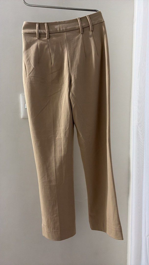 Bershka Beige Tailored Trouser (Category: Other Bottoms) located in Manila. Submitted by ceethingsout (Listing ID 1458175247, Image 3). Description: - Beige tailored pants from Bershka - Cropped length with a flared hem - Button and zip closure - Two front pockets - Versatile for work or casual outfits *very nice fit, used only twice. .