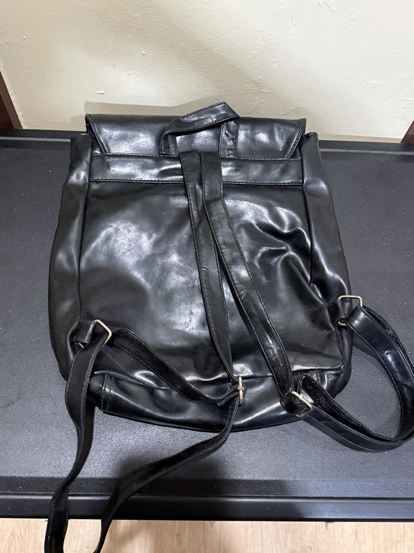Black Faux Leather Backpack with Buckle Closures (Category: Backpacks) located in Manila. Submitted by gooddealsmanila (Listing ID 1458279891, Image 2). Description: - Chic black backpack with a faux leather finish. - Secure flap closure with two front buckle straps. - Comfortable top handle and adjustable shoulder straps. - Spacious interior for all your essentials. - Ideal for everyday wear and school..