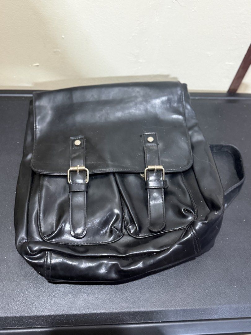 Black Faux Leather Backpack with Buckle Closures (Category: Backpacks) located in Manila. Submitted by gooddealsmanila (Listing ID 1458279891, Image 1). Description: - Chic black backpack with a faux leather finish. - Secure flap closure with two front buckle straps. - Comfortable top handle and adjustable shoulder straps. - Spacious interior for all your essentials. - Ideal for everyday wear and school..