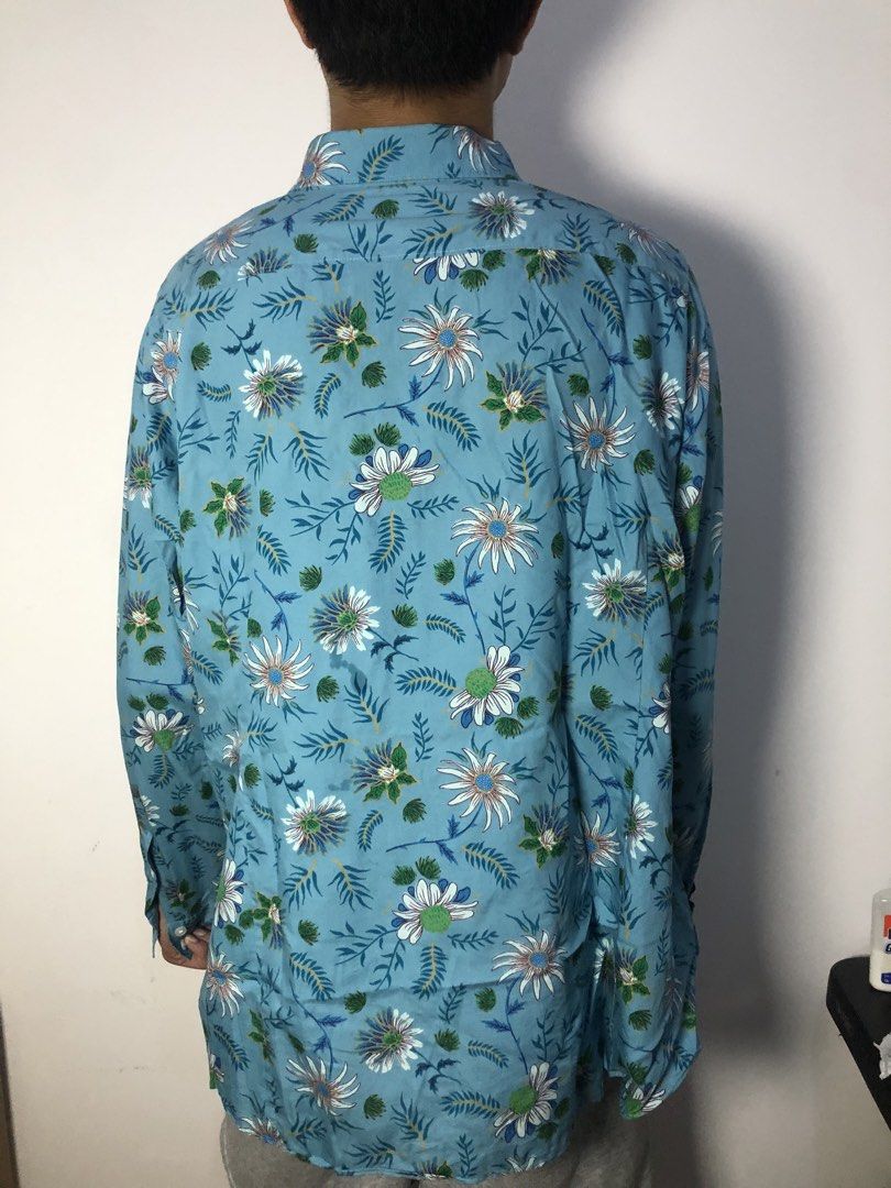 Blue Floral Long Sleeve Button Up Shirt (Category: Longsleeves) located in General Trias. Submitted by previouslyadored147 (Listing ID 1458190804, Image 2). Description: - Cool blue long-sleeve shirt - White and green floral print - Button-up front - Versatile for casual wear or a night out - Easy to pair with jeans or shorts.