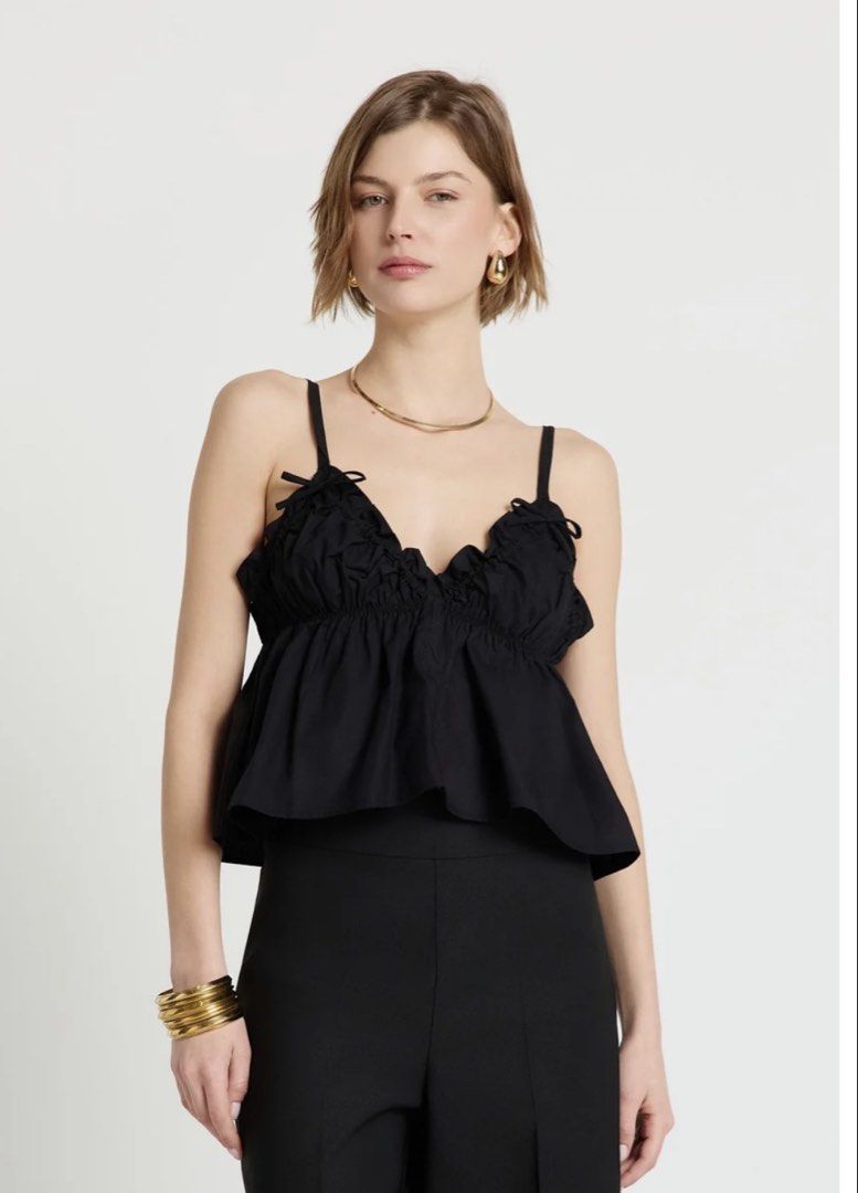 CALLIOPE Top with Ruching and Bows (Category: Sleeveless) located in Quezon City. Submitted by shesellstrinkets (Listing ID 1458251816, Image 1). Description: CALLIOPE Top Worn once V-neck and thin adjustable straps, ruching on the bust and bow details. Soft, flared shape with frills and an elastic insert under the bust. Tag says small but can fit from S to XL. Helping tags: cotton on, babydoll, cropped top, chic tops.