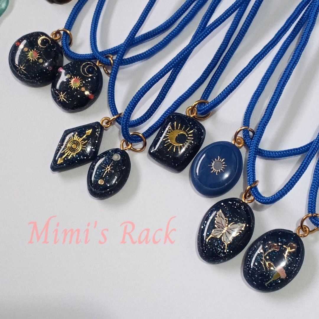 Celestial Decoupage Pendant Necklace (Category: Necklaces) located in Taguig. Submitted by mimisrack (Listing ID 1458266352, Image 1). Description: 💙Beautiful handmade-style pendant necklaces featuring dark blue celestial designs with gold-tone details, colorful accents, and a matching blue cord. ✨💙 -Each pendant has its own unique design—from moons and stars to sun motifs, butterflies, and floral details—so you can choose the one that matches 
