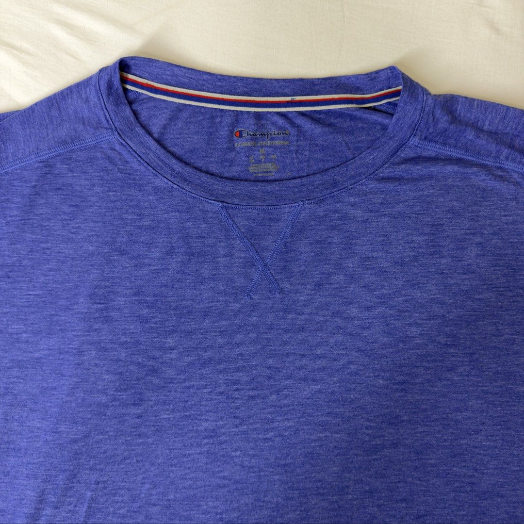 Champion Blue T-Shirt Size M (Category: Shirts) located in Angeles City. Submitted by muse_archive (Listing ID 1458172332, Image 3). Description: - Champion T-Shirt - Color: Blue with Black Sleeves - Size: Medium (M) - Features: Heathered fabric texture, blue and light blue stripes on sleeves - Style: Casual wear or sports - Fit: Comfortable.