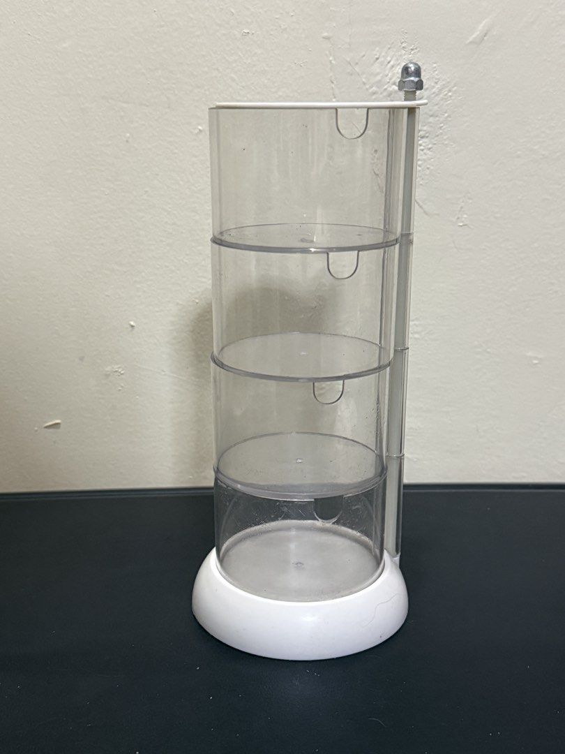 Clear Rotating 3-Tier Storage Organizer Stand (Category: Storage Boxes & Baskets) located in Manila. Submitted by gooddealsmanila (Listing ID 1458280242, Image 1). Description: - 3-Tier Rotating Storage Organizer - White, round base - Ideal for organizing small items on desks or vanities - Keeps items tidy and easily accessible - Smooth spinning action for convenient retrieval.