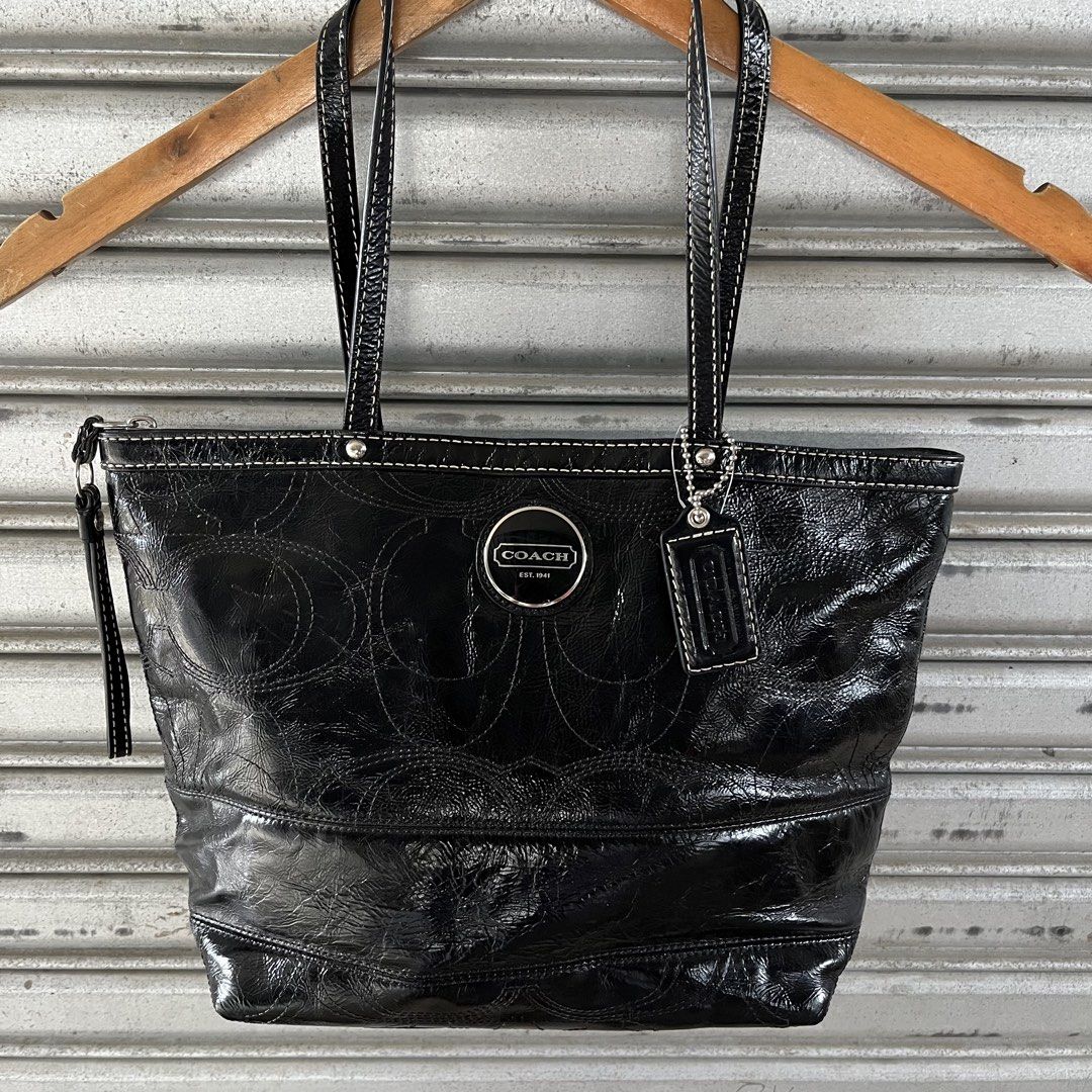 Coach Black Patent Leather Monogram Tote Bag (Category: Luxury Bags & Wallets) located in Sagbayan (Borja). Submitted by lunapawpaw46843 (Listing ID 1458194423, Image 2). Description: - Authentic Black Coach Tote Bag - Luxurious Patent Leather with Embossed Monogram - Elegant White Stitching Details - Shiny Silver Hardware - Iconic Coach Logo and Hangtag - Secure Zipper Closure - Ideal Everyday Bag.