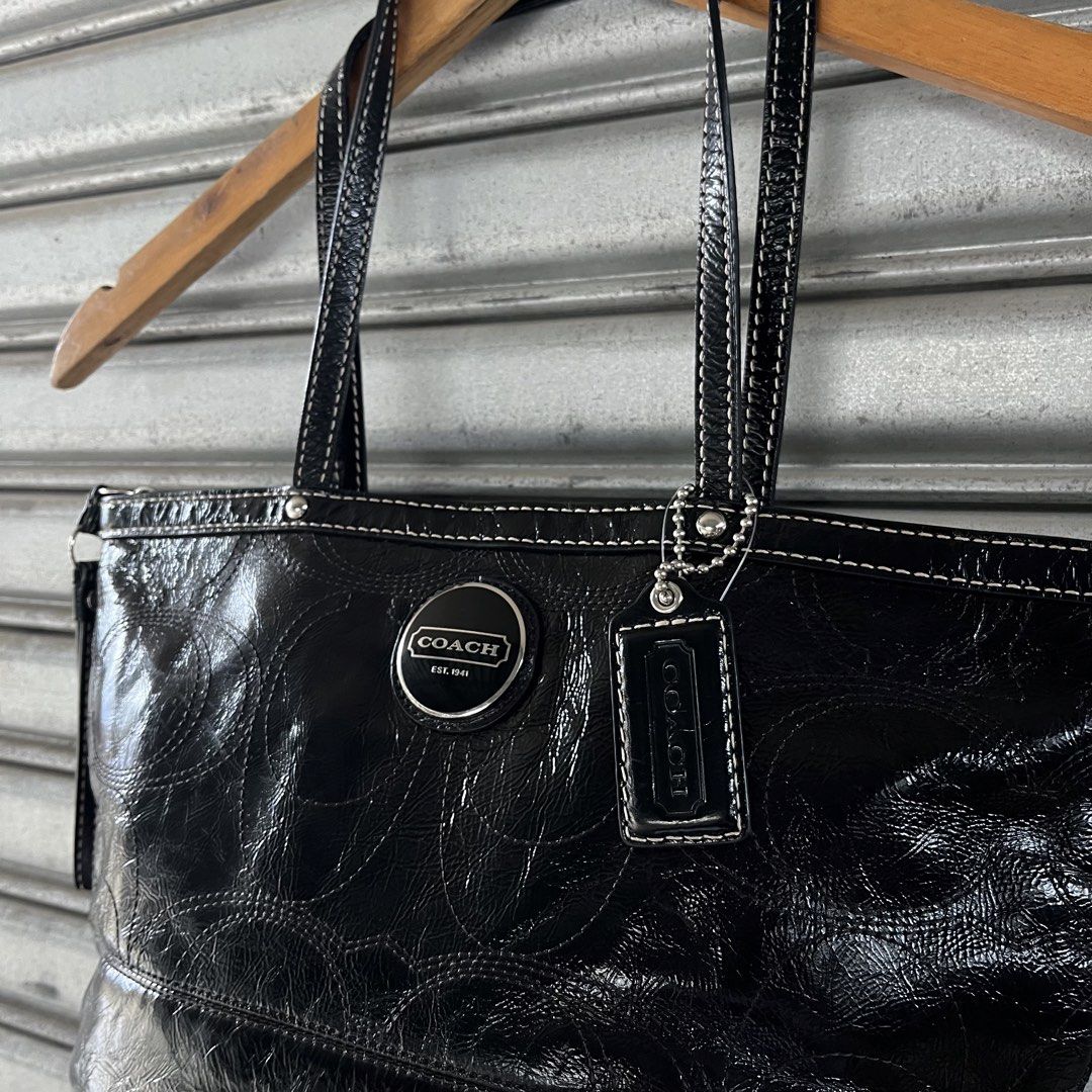 Coach Black Patent Leather Monogram Tote Bag (Category: Luxury Bags & Wallets) located in Sagbayan (Borja). Submitted by lunapawpaw46843 (Listing ID 1458194423, Image 3). Description: - Authentic Black Coach Tote Bag - Luxurious Patent Leather with Embossed Monogram - Elegant White Stitching Details - Shiny Silver Hardware - Iconic Coach Logo and Hangtag - Secure Zipper Closure - Ideal Everyday Bag.