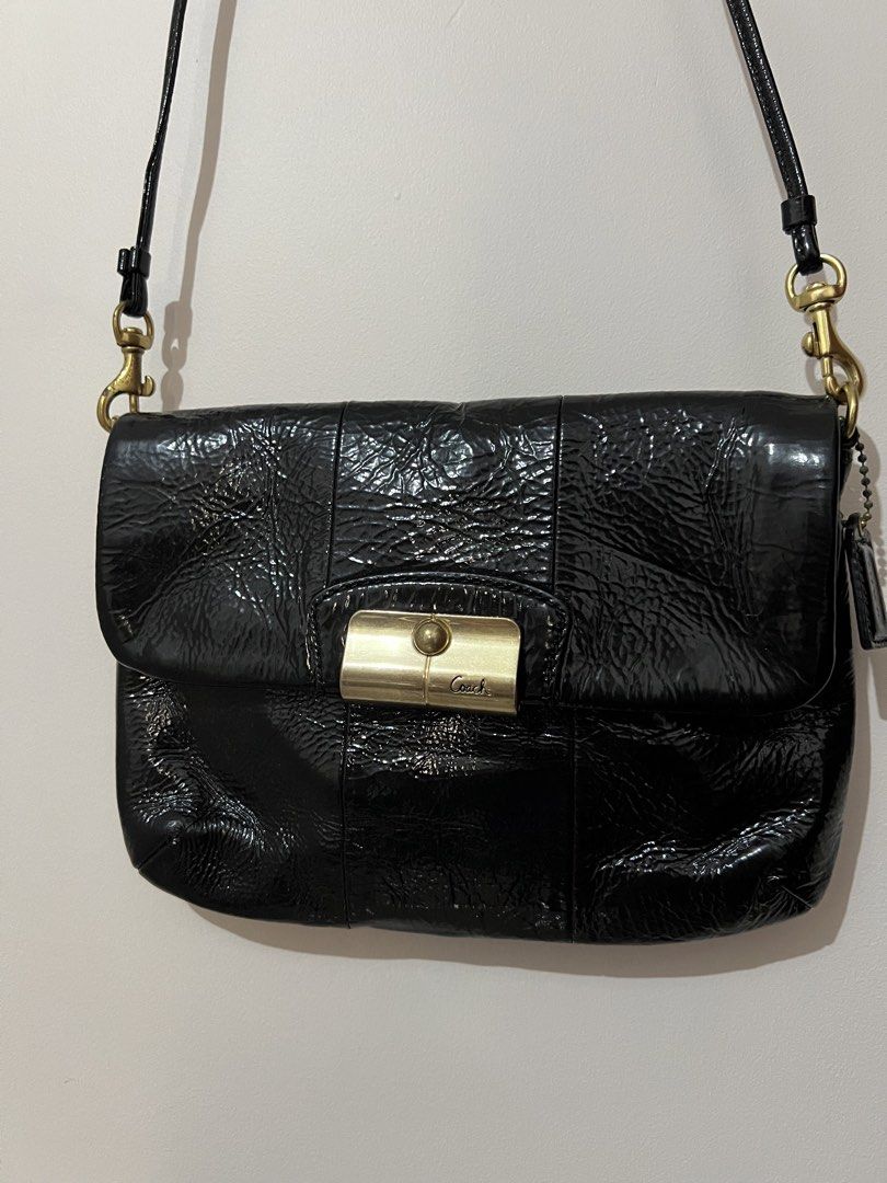Coach Black Patent Leather Shoulder Bag (Category: Luxury Bags & Wallets) located in San Juan, La Union. Submitted by jacquiqui (Listing ID 1458157839, Image 1). Description: - Coach black patent leather shoulder bag - Gold-tone clasp closure - Coach logo tag - Interior with multiple card slots - Non-adjustable strap - Stain on lining due to metal clasp and age .