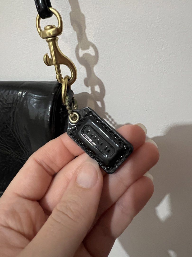 Coach Black Patent Leather Shoulder Bag (Category: Luxury Bags & Wallets) located in San Juan, La Union. Submitted by jacquiqui (Listing ID 1458157839, Image 3). Description: - Coach black patent leather shoulder bag - Gold-tone clasp closure - Coach logo tag - Interior with multiple card slots - Non-adjustable strap - Stain on lining due to metal clasp and age .