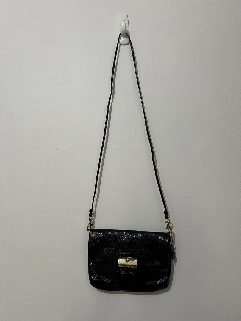 Coach Black Patent Leather Shoulder Bag (Category: Luxury Bags & Wallets) located in San Juan, La Union. Submitted by jacquiqui (Listing ID 1458157839, Image 2). Description: - Coach black patent leather shoulder bag - Gold-tone clasp closure - Coach logo tag - Interior with multiple card slots - Non-adjustable strap - Stain on lining due to metal clasp and age .