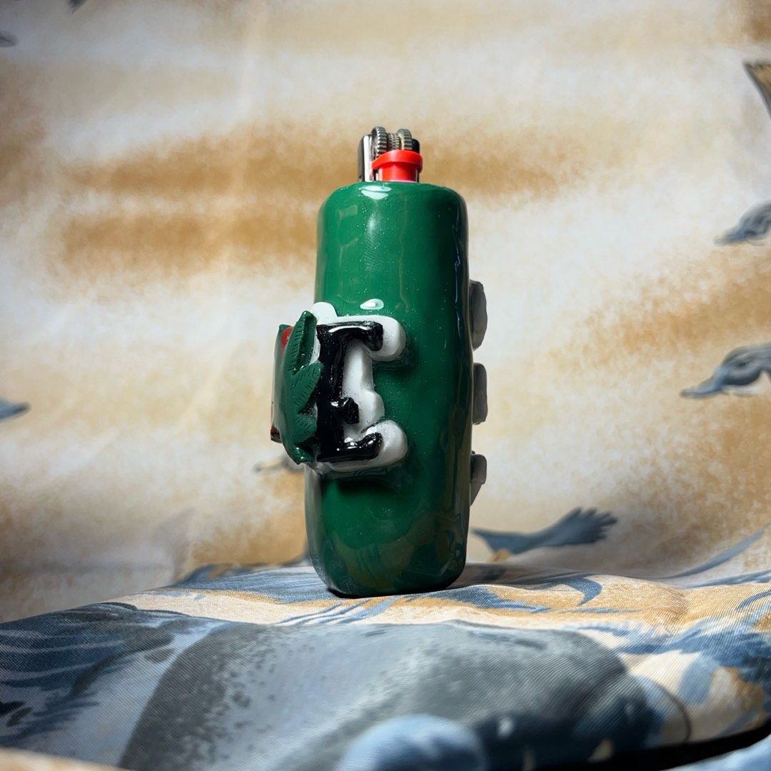 Custom Green Lighter Case with 'I Love 420' Design (Category: Vintage Collectibles) located in Quezon City. Submitted by chikinita (Listing ID 1458256822, Image 2). Description: -Lighter Included -For standard BIC (J3) -Instagram: Claymado - Cool green lighter case - Features custom 'I Love 420' and weed leaf design - Fits standard Bic lighters - Perfect for personal use or as a unique gift.