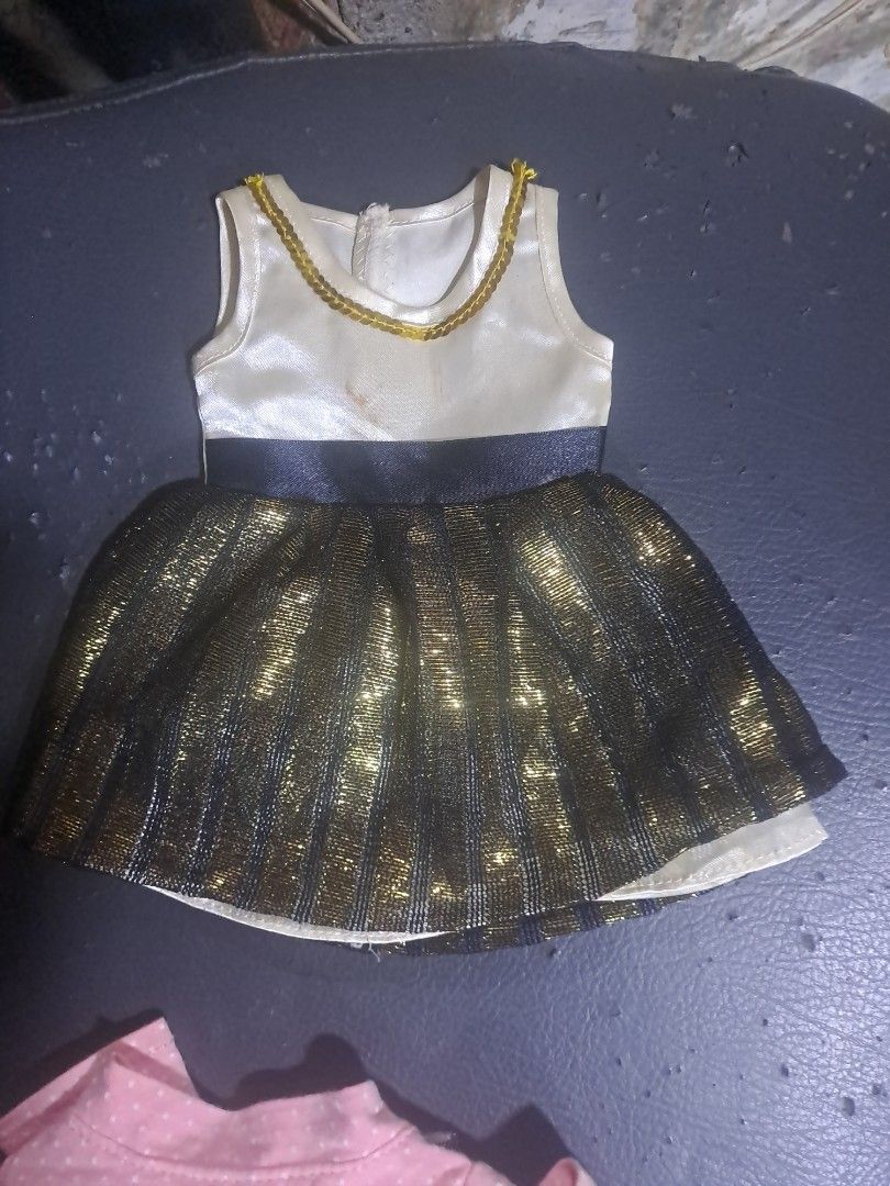 Doll Clothes Set - Various Outfits (Category: Babies & Kids Fashion) located in Davao. Submitted by bravemoon_556cd5 (Listing ID 1458166468, Image 2). Description: - Red lace dress with gold trim - Sparkly gold and black dress - Black and orange tutu - Purple Batgirl costume - Denim jacket - All items are for dolls - Great for dress-up play or collectors.
