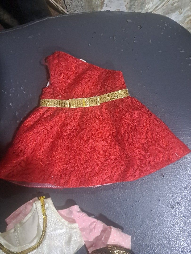 Doll Clothes Set - Various Outfits (Category: Babies & Kids Fashion) located in Davao. Submitted by bravemoon_556cd5 (Listing ID 1458166468, Image 1). Description: - Red lace dress with gold trim - Sparkly gold and black dress - Black and orange tutu - Purple Batgirl costume - Denim jacket - All items are for dolls - Great for dress-up play or collectors.