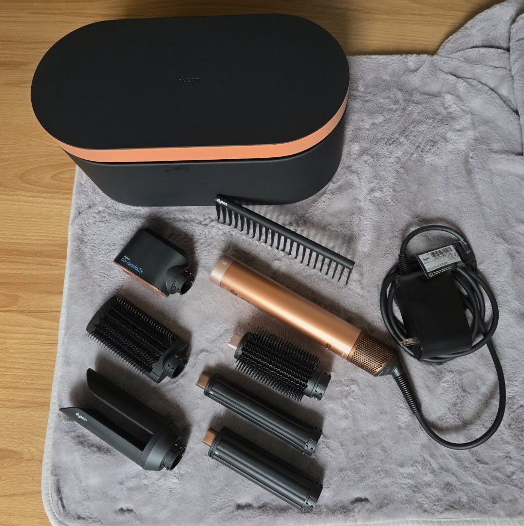 Dyson Airwrap Co-anda2x in Amber Silk (Category: Hair) located in Quezon City. Submitted by mimiandyanagi (Listing ID 1458112043, Image 3). Description: - Dyson Airwrap Co-anda2x (Amber Silk) - Includes all attachments shown: coanda2x curling barrels, anti-snag brush, volumizing brush, pre-styling fast dryer, and Airsmooth2x attachment - Comes with original storage case and charger. No name engraving - Comes with a detangling comb - Purchased on 