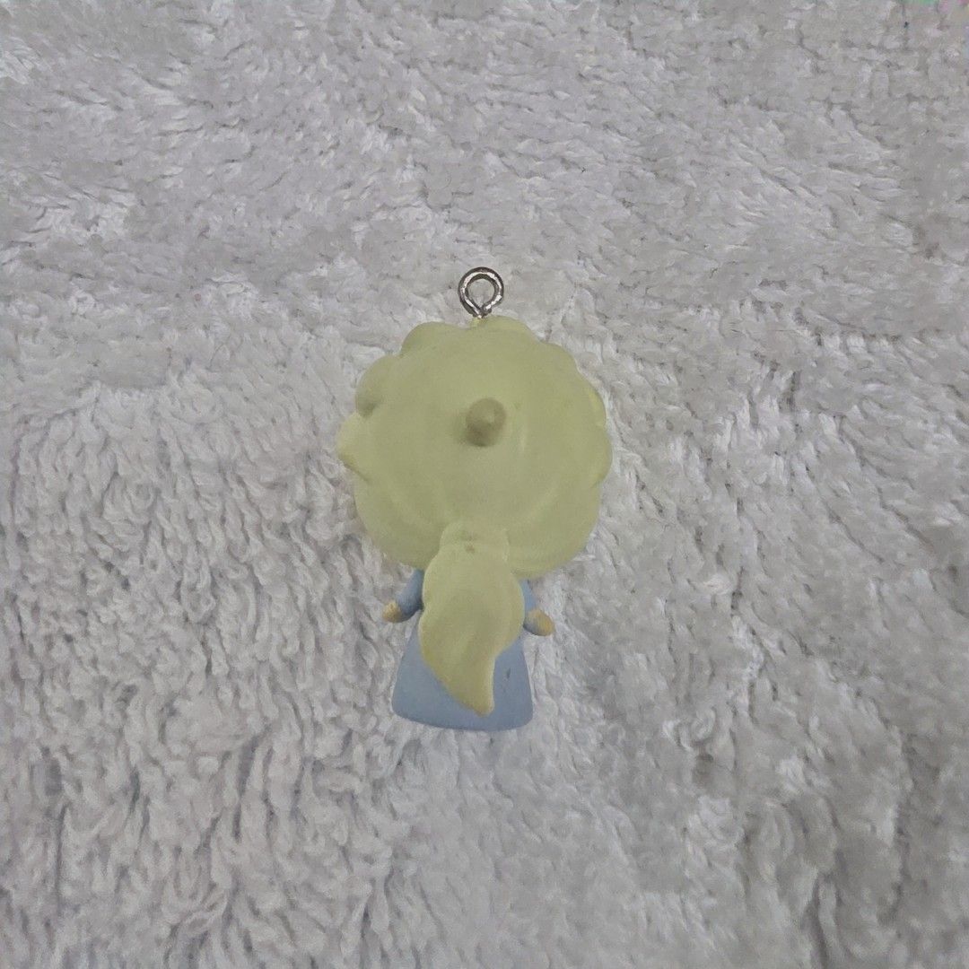 Elsa Disney Frozen Phone Charm (Category: Character Goods) located in Pasig City. Submitted by aerasdrafts (Listing ID 1458267152, Image 2). Description: Character: Elsa, the Snow Queen, recognizable by her pale blonde hair swept back into her iconic braid and her light blue dress. Format: A small vinyl or rubber mini-figure designed as a deformed/chibi (deforme) charm, featuring an eyelet screw at the top meant for attaching a keychain loop or a