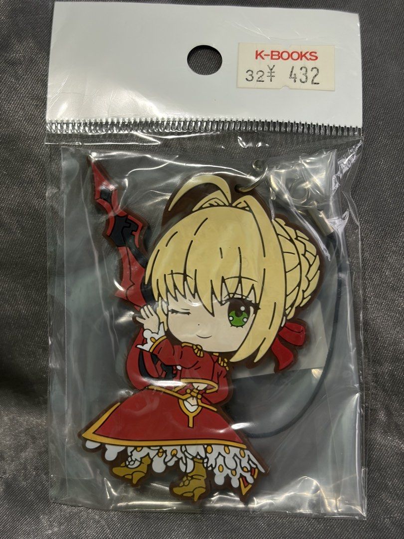 Fate/Grand Order Saber Nero Rubber Keychain (Category: Character Goods) located in Mandaluyong City. Submitted by cat_master (Listing ID 1458189882, Image 1). Description: - Brand new, still in original packaging - Features Saber Nero from Fate/Grand Order - Adorable design with Nero in her iconic red dress - Includes a strap for easy attachment to bags, backpacks, or keys - A must-have collectible for fans of the series.