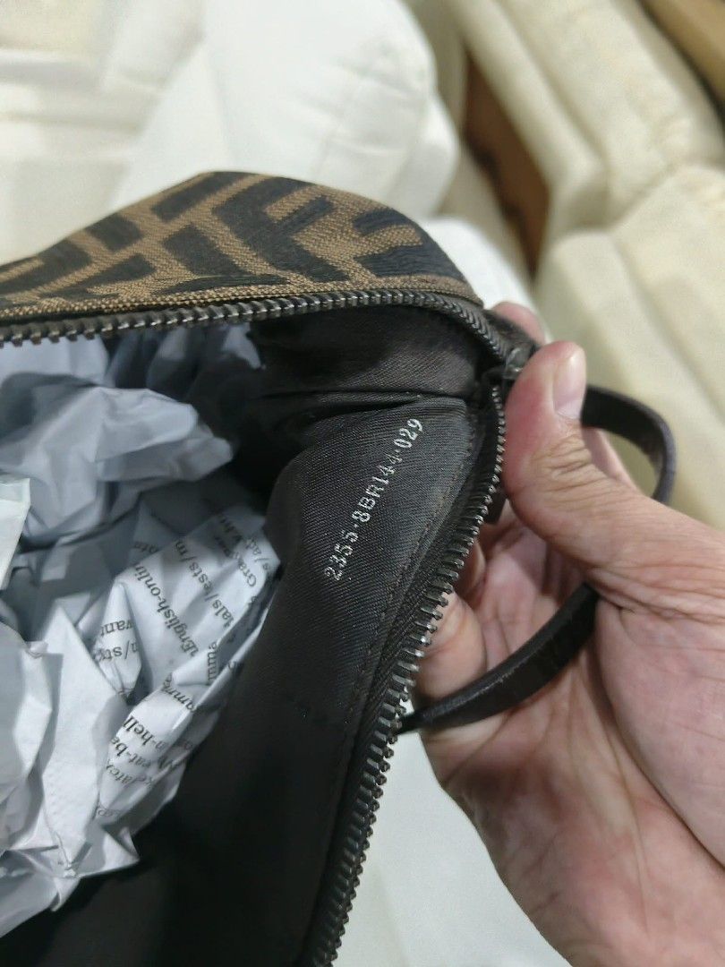 Fendi Zucca Canvas Mini Baguette Shoulder Bag (Category: Luxury Bags & Wallets) located in Gapan. Submitted by cleverstar.36492b (Listing ID 1458183089, Image 2). Description: Authentic Fendi mini baguette bag. Classic Zucca canvas pattern. Zipper closure. Interior has a small tag with serial number 2255.8BR144.029. Made in Italy. Small and compact, great for essentials. Handle is black leather..